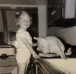 girl with uncooked Thanksgiving turkey