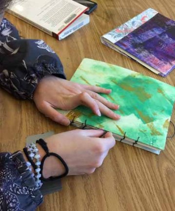 Student finishing hand sewn book