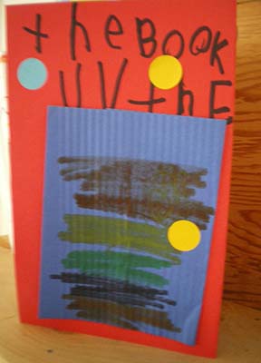 The cover of a child's book decorated with a rectangle of corrugated paper. The text says, "the Book UV the."