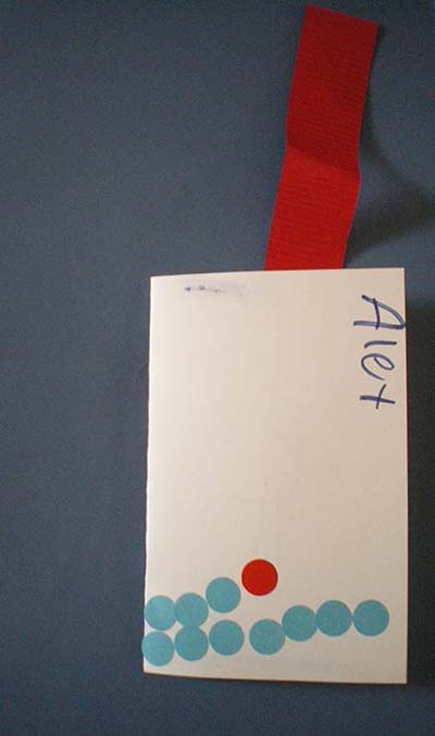 The cover of a child's book showing a handwritten name, Alex