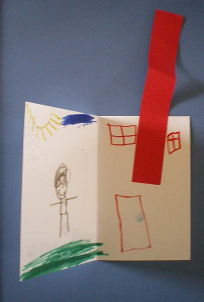 Interior of child's book showing a person and a house with a tall chimney